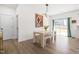 The dining room area features a modern light fixture and access to the backyard through sliding glass doors at 74 Silver Moon Ln, Clayton, NC 27527