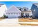 Charming single-Gathering home with a two-car garage and well-manicured front yard at 74 Silver Moon Ln, Clayton, NC 27527