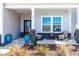 Inviting front porch with stylish decor, seating, and charming curb appeal at 74 Silver Moon Ln, Clayton, NC 27527