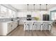 Well-lit kitchen features white cabinets, a spacious island with seating, and stainless steel appliances at 74 Silver Moon Ln, Clayton, NC 27527