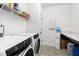 Functional laundry room with modern appliances, shelving for storage, and a utility sink at 74 Silver Moon Ln, Clayton, NC 27527