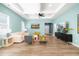 Comfortable living room with an open floor plan, hardwood floors, and a stylish tray ceiling at 74 Silver Moon Ln, Clayton, NC 27527