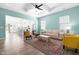 Bright open-concept living room with tray ceiling, hardwood floors, and seamless flow to the kitchen at 74 Silver Moon Ln, Clayton, NC 27527