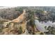 Scenic aerial view of a road running along a lake in a wooded area at 75 Traceway N, Sanford, NC 27332
