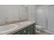 Bathroom featuring double sinks with tile floor, white walls, and shower with glass door at 75 Traceway N, Sanford, NC 27332