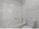 Bathroom with white bathtub and shower combination with a white toilet at 75 Traceway N, Sanford, NC 27332