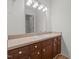 Bathroom with a large mirror, dark cabinets, and a white countertop and sink at 75 Traceway N, Sanford, NC 27332