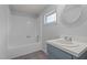 Bathroom featuring a bathtub, shower, and a sink with blue cabinets at 75 Traceway N, Sanford, NC 27332