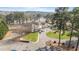 Aerial view of a grand clubhouse with lake views, surrounded by landscaped grounds at 75 Traceway N, Sanford, NC 27332