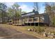 Charming exterior view showcasing a large wooden deck, neutral siding, and a sloped backyard at 75 Traceway N, Sanford, NC 27332