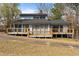 Exterior of home with a large wooden deck, neutral siding, and a sloped backyard at 75 Traceway N, Sanford, NC 27332