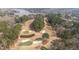 Aerial view of the golf course, trees, and lake at 75 Traceway N, Sanford, NC 27332