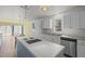 Bright kitchen with white cabinetry, stainless appliances, and island cooktop at 75 Traceway N, Sanford, NC 27332