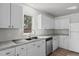 Bright kitchen with white cabinetry and stainless steel appliances at 75 Traceway N, Sanford, NC 27332