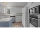 Bright kitchen with white cabinetry, stainless appliances, and built-in microwave at 75 Traceway N, Sanford, NC 27332