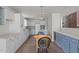 Bright kitchen features white cabinets, stainless appliances, and a wood table with seating at 75 Traceway N, Sanford, NC 27332