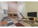 Bright living room with brick fireplace and a staircase leading to the second floor at 75 Traceway N, Sanford, NC 27332