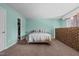 Spacious primary bedroom with large window and exposed brick wall, closet, and teal walls at 75 Traceway N, Sanford, NC 27332