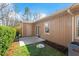 Backyard patio with a grassy area, lush greenery, and mature trees at 7914 Yester Ct, Raleigh, NC 27615
