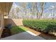 Backyard patio with a grassy area, lush greenery, and privacy fence at 7914 Yester Ct, Raleigh, NC 27615