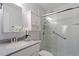 Modern bathroom with a sleek glass-enclosed shower, vanity with granite countertop, and ample natural light at 7914 Yester Ct, Raleigh, NC 27615
