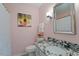 Charming bathroom with granite countertops, framed mirror, and stylish light fixture at 7914 Yester Ct, Raleigh, NC 27615
