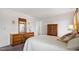 Well-lit bedroom featuring a dresser and armoire, offering a serene and stylish space for relaxation at 7914 Yester Ct, Raleigh, NC 27615