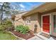 Close up of front entrance. A red door, a potted plant, and a welcome mat at 7914 Yester Ct, Raleigh, NC 27615