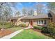Charming home with tan siding, manicured lawn, and walkway leading to the front door at 7914 Yester Ct, Raleigh, NC 27615