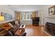 Cozy living room with hardwood floors, a decorative fireplace, and a window for natural light at 7914 Yester Ct, Raleigh, NC 27615