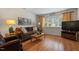 Comfortable living room with beautiful hardwood flooring, sofa, and large picture window at 7914 Yester Ct, Raleigh, NC 27615