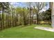 Expansive backyard with mature trees and storage building at 804 E D St, Butner, NC 27509