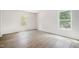 Inviting bedroom featuring hardwood flooring and two bright windows for natural light at 804 E D St, Butner, NC 27509
