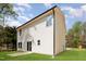Back exterior of two-story home featuring manicured lawn and egress to back yard at 804 E D St, Butner, NC 27509