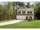 View of the two-story home, with attached garage and a large front lawn at 804 E D St, Butner, NC 27509