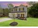 Charming two-story home with lush lawn and manicured landscaping at 804 E D St, Butner, NC 27509