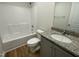 Cozy bathroom featuring a tub with shower and granite countertops with a single sink at 95 Tulipfield Way, Benson, NC 27504