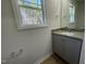 Bathroom showcasing a granite countertop vanity, framed mirror, window views, and wood-look vinyl flooring at 95 Tulipfield Way, Benson, NC 27504