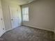 Neutral bedroom with carpet, a window for natural light and a closet for storage at 95 Tulipfield Way, Benson, NC 27504