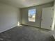 Bright bedroom with plush carpet, a window for natural light, and a neutral color palette at 95 Tulipfield Way, Benson, NC 27504