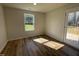 Bedroom showcasing wood-look vinyl flooring, a large window, and an exterior door leading to the deck at 95 Tulipfield Way, Benson, NC 27504