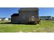 Exterior view of house with gray siding and a small backyard deck with stairs at 95 Tulipfield Way, Benson, NC 27504
