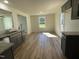 Modern kitchen showcasing granite countertops, gray cabinets, and stainless steel appliances with a view to the living room at 95 Tulipfield Way, Benson, NC 27504