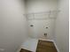 The laundry room features connections for washer/dryer and a wire rack for storage at 95 Tulipfield Way, Benson, NC 27504