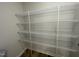 Pantry equipped with ample metal shelving units, providing convenient storage solutions and wood-look vinyl flooring at 95 Tulipfield Way, Benson, NC 27504