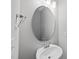 Powder room with an oval mirror, chrome fixtures, and a white vanity at 96 Ripple Way # 316, Clayton, NC 27520