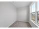 Bedroom featuring neutral carpet, light gray walls, and a bright window at 96 Ripple Way # 316, Clayton, NC 27520