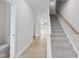 Bright foyer with wood-look flooring, carpeted stairs, and white trim accents at 96 Ripple Way # 316, Clayton, NC 27520