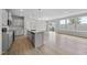 Bright open-concept kitchen with an island and stainless steel appliances overlooking the dining area at 96 Ripple Way # 316, Clayton, NC 27520