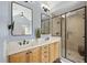 Bathroom featuring double vanity, granite countertop, framed mirrors, and tiled walk-in shower at 1001 Hazeltown Rd, Wake Forest, NC 27587